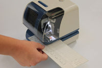 The Amano Time Stamp clock-in machine in the process of stamping someone's time card