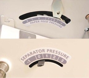 This is an image of the paper feed/Separator pressure adjustment. Paper feed pressure adjustment helps the machine to feed a wider range of stocks, and the separator pressure adjustment prevents double feeds.